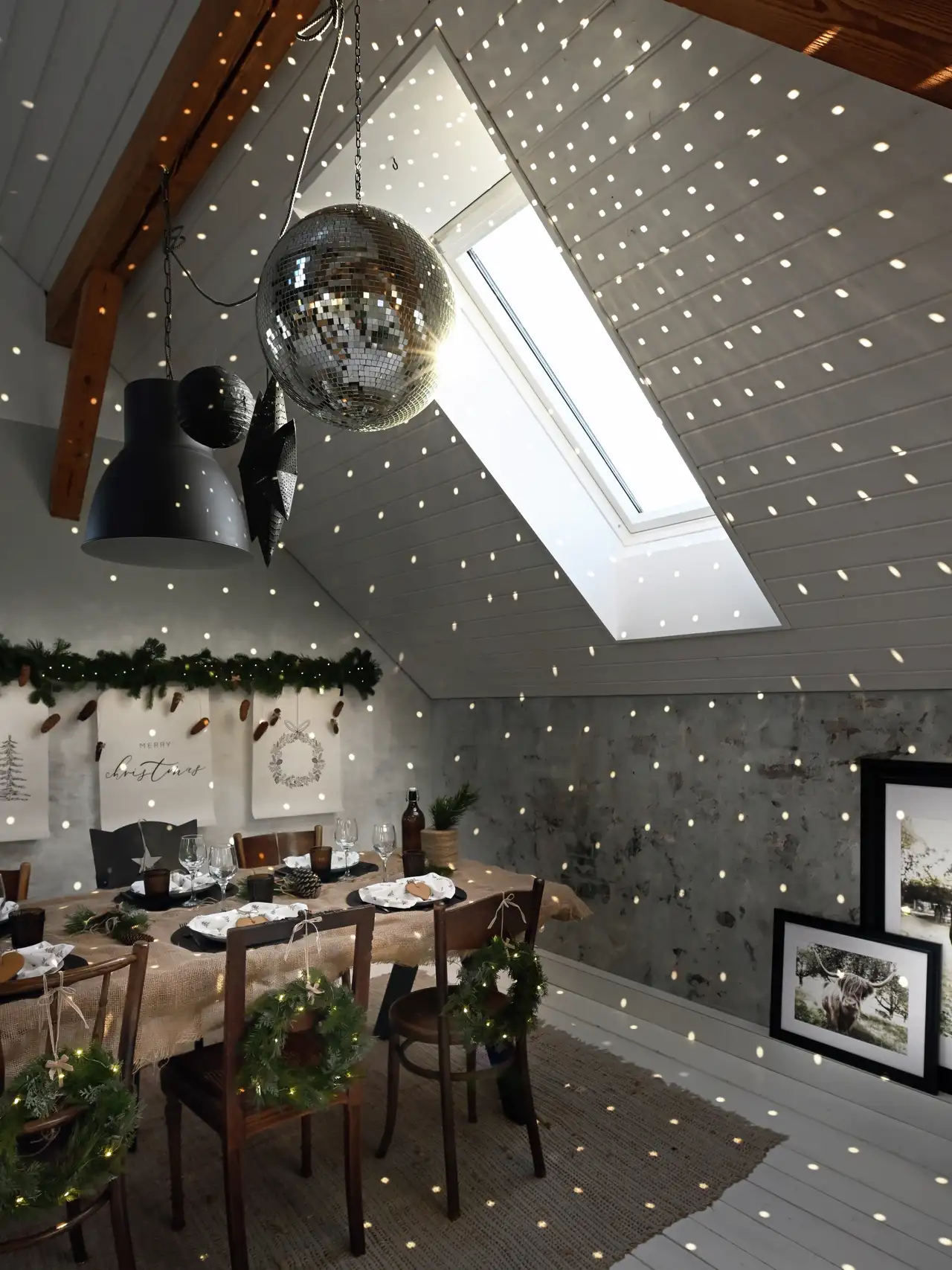 Attic dining room with holiday decorations, sloped ceiling, and VELUX roof window. 