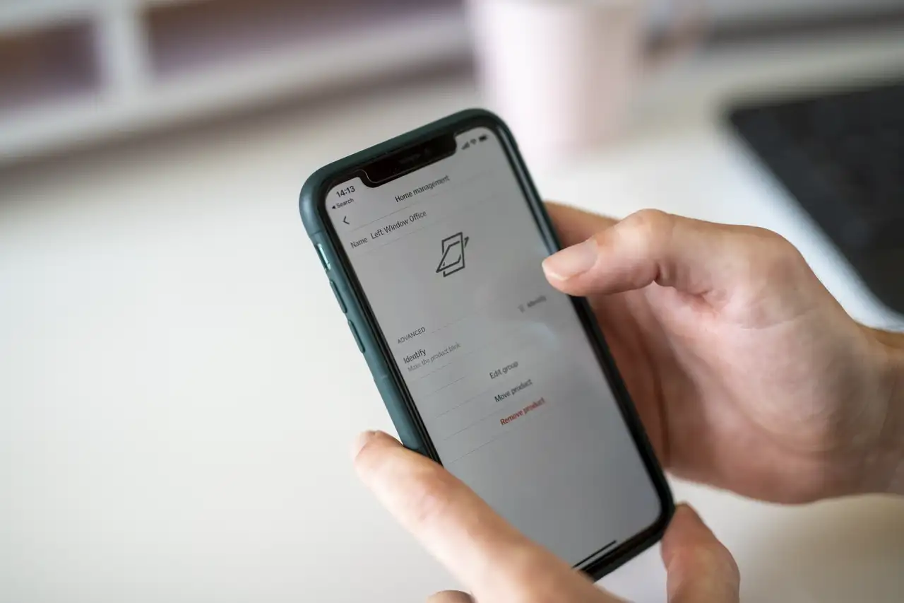 Smartphone showing smart home app interface for window control