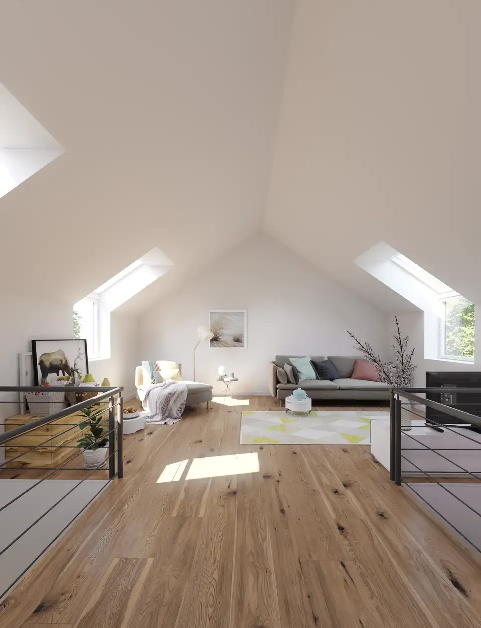 Ampio open space in mansarda con pavimento in legno, pareti bianche e più finestre per tetti VELUX a illuminare l’ambiente. 