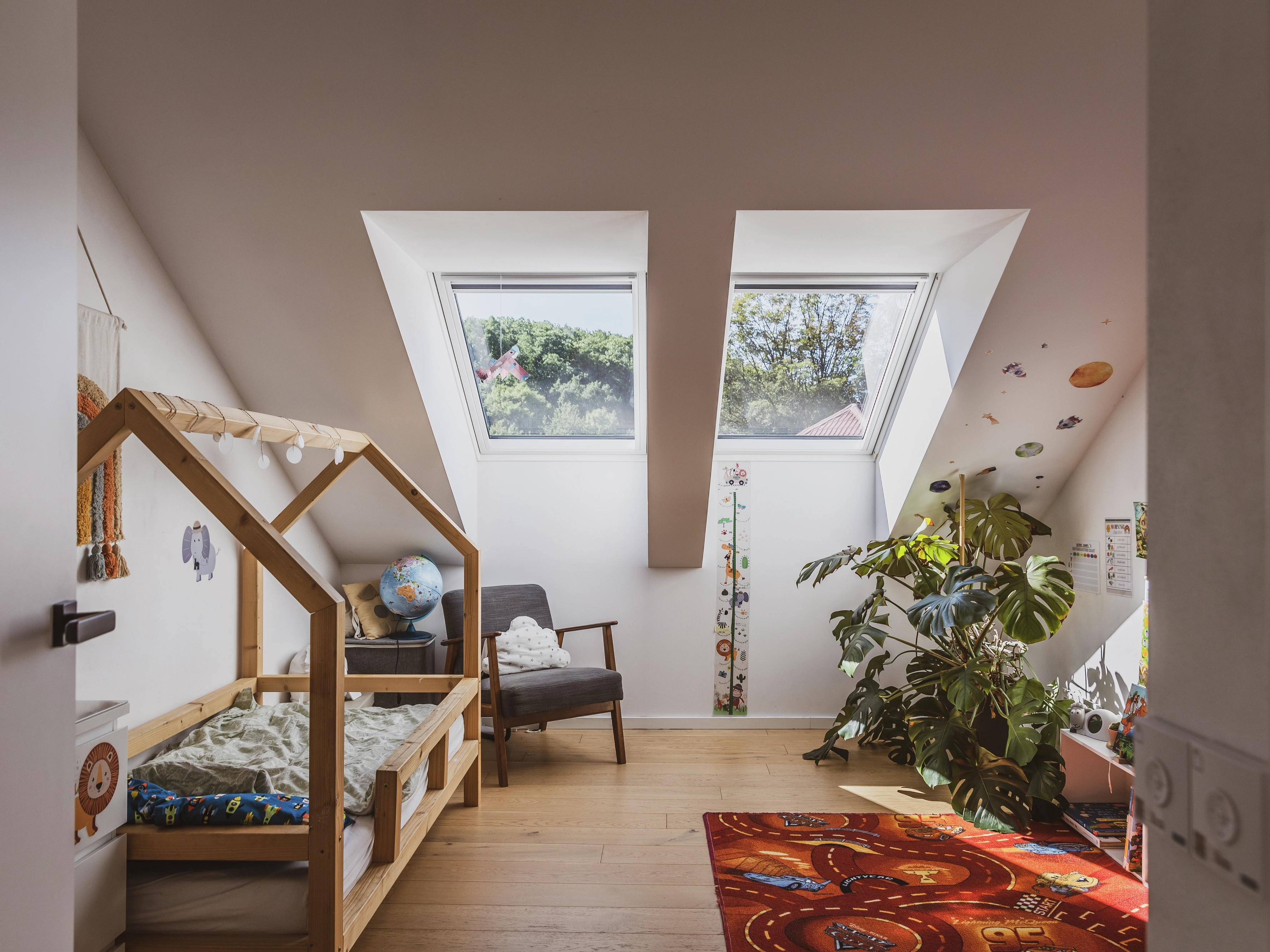 Attic kids room with sloped ceiling and VELUX roof windows.