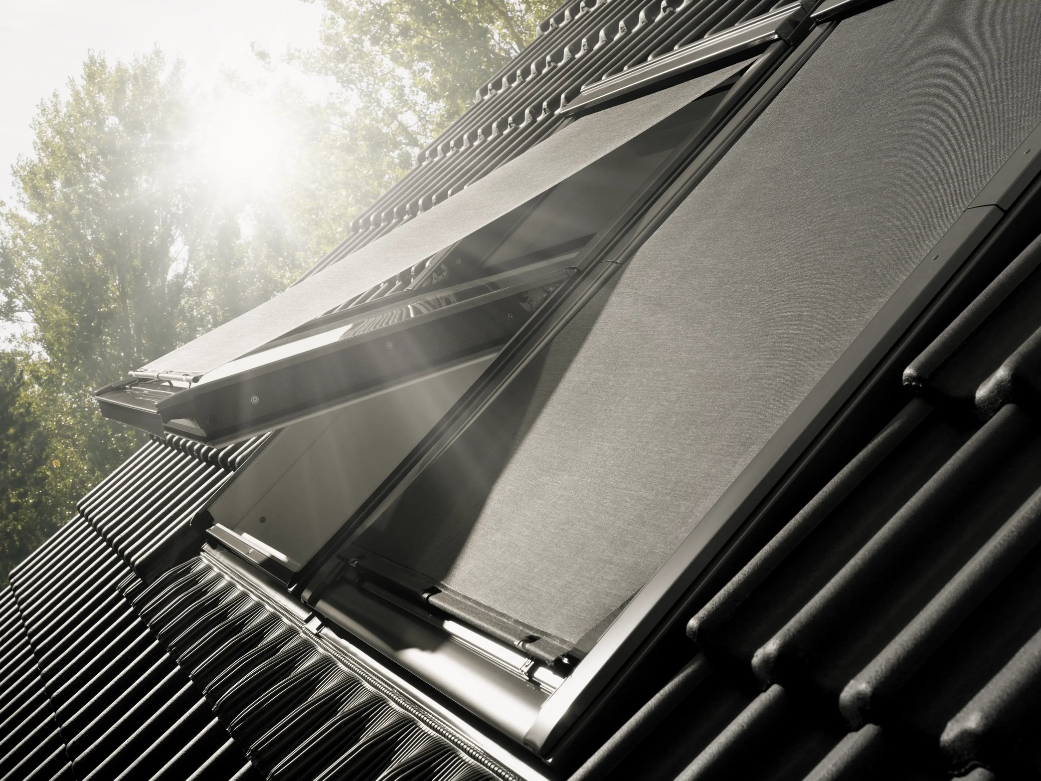 VELUX roof window with open shade, sunlight streaming through.