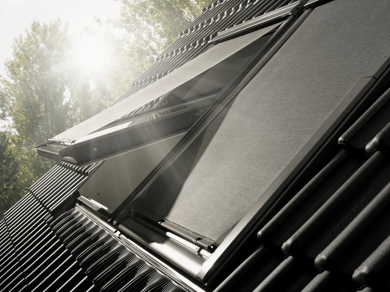 VELUX roof window with open shade, sunlight streaming through.