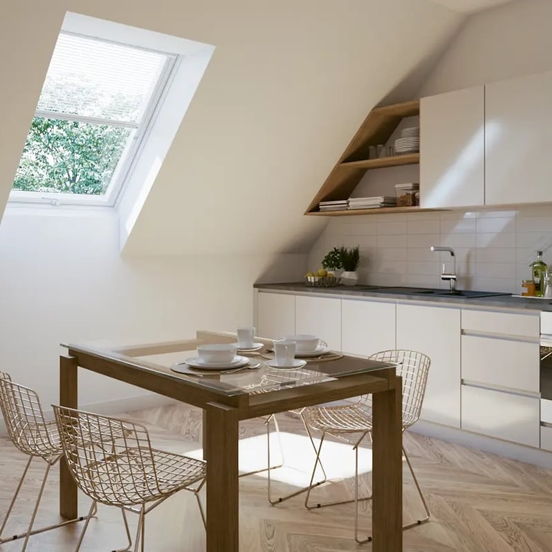 Attic kitchen with sloped ceiling and VELUX roof window, bright and modern.