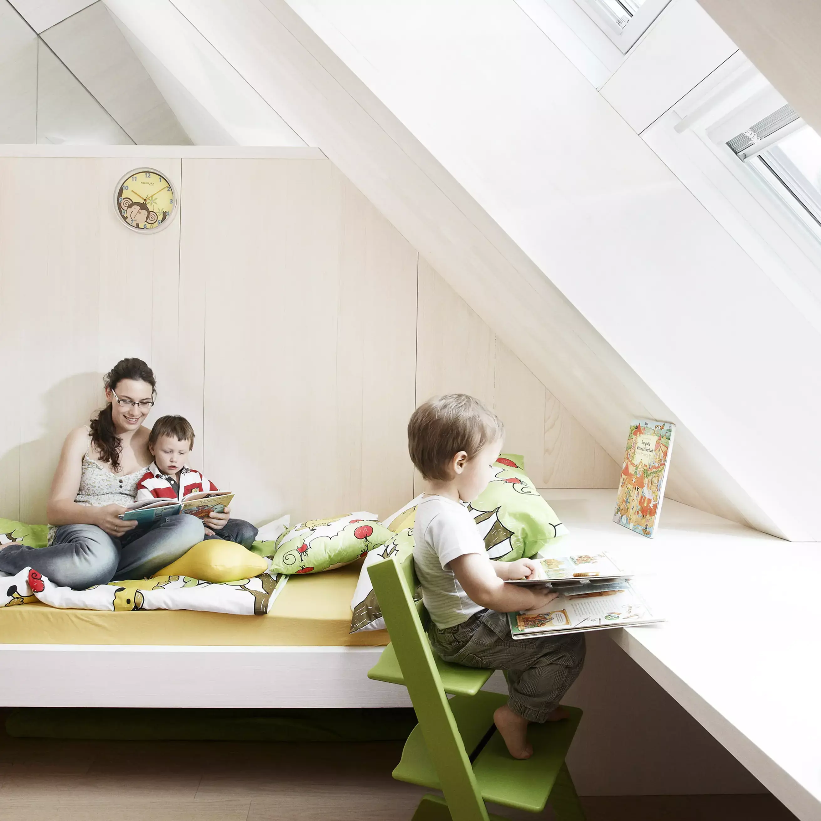 Attic kids room with sloped ceiling and VELUX roof window, bright and cozy.