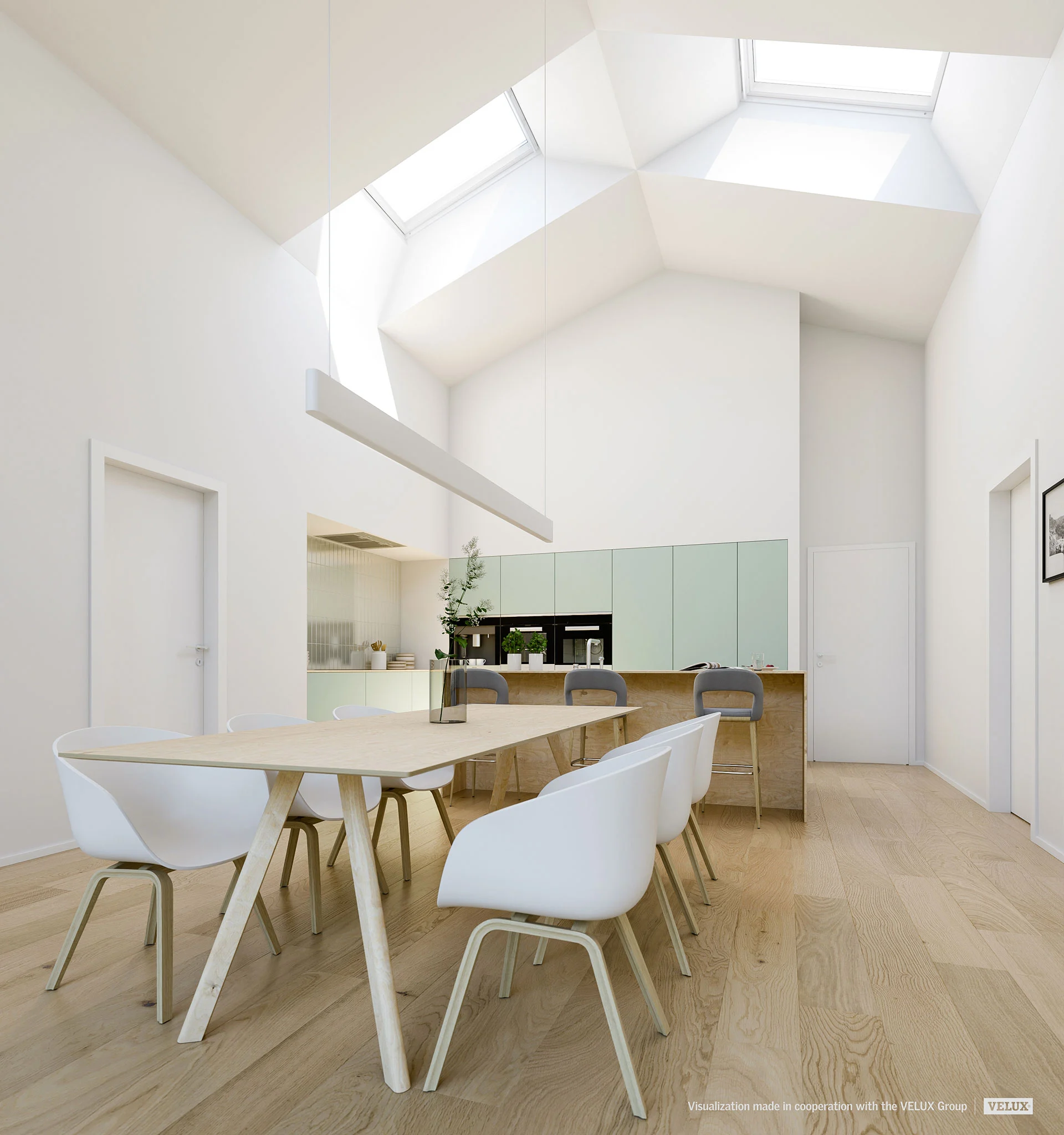 Table rectangulaire éclairée par des fenêtres de toit VELUX et une suspension