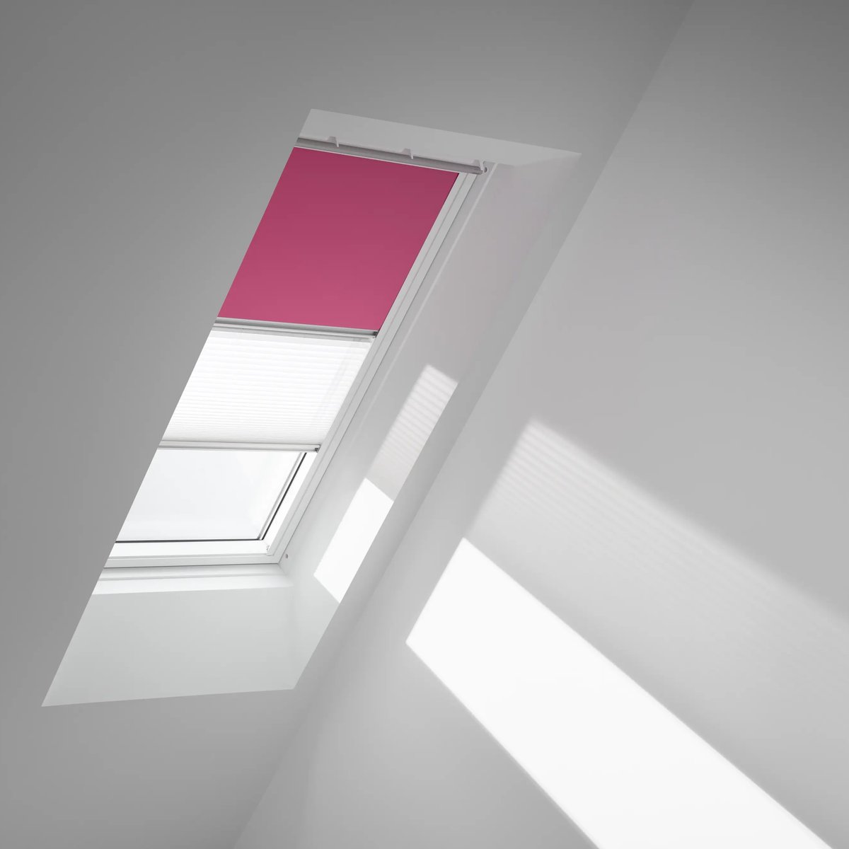 Attic with sloped ceiling and VELUX roof window, natural light entering.