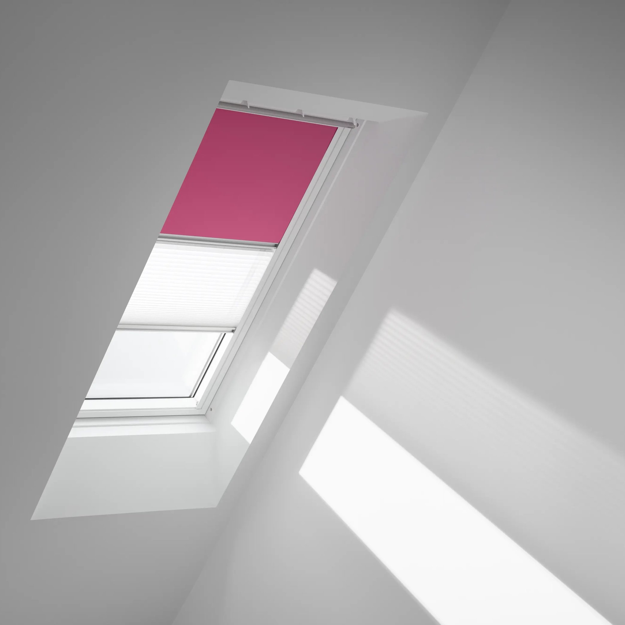Attic with sloped ceiling and VELUX roof window, natural light entering.