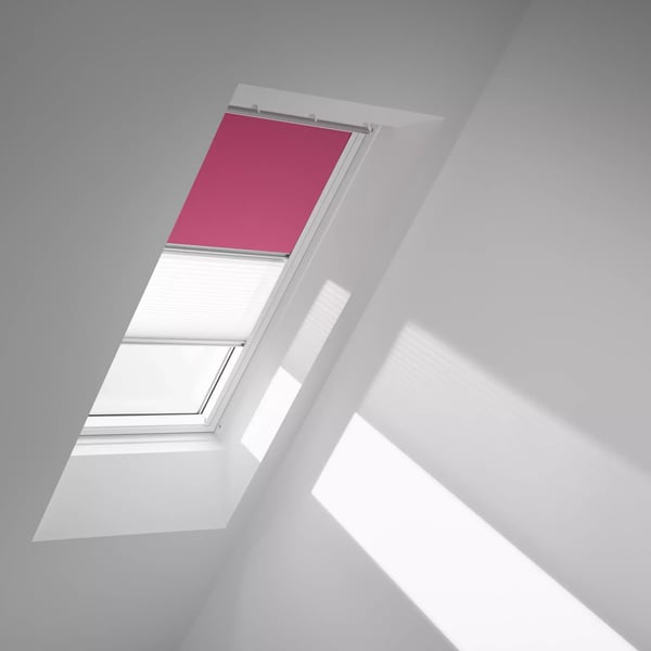 Attic with sloped ceiling and VELUX roof window, natural light entering.