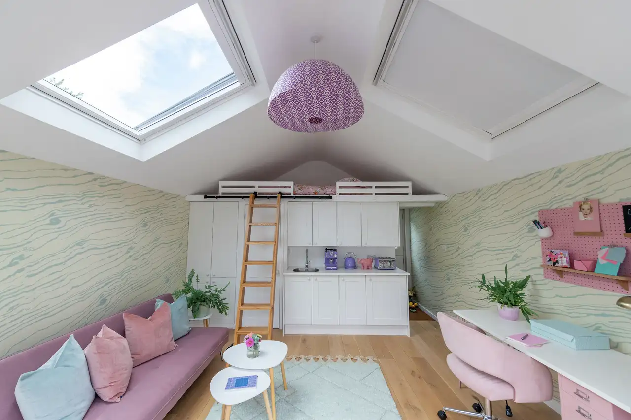 Modern attic with high bed and sloped ceiling with VELUX windows