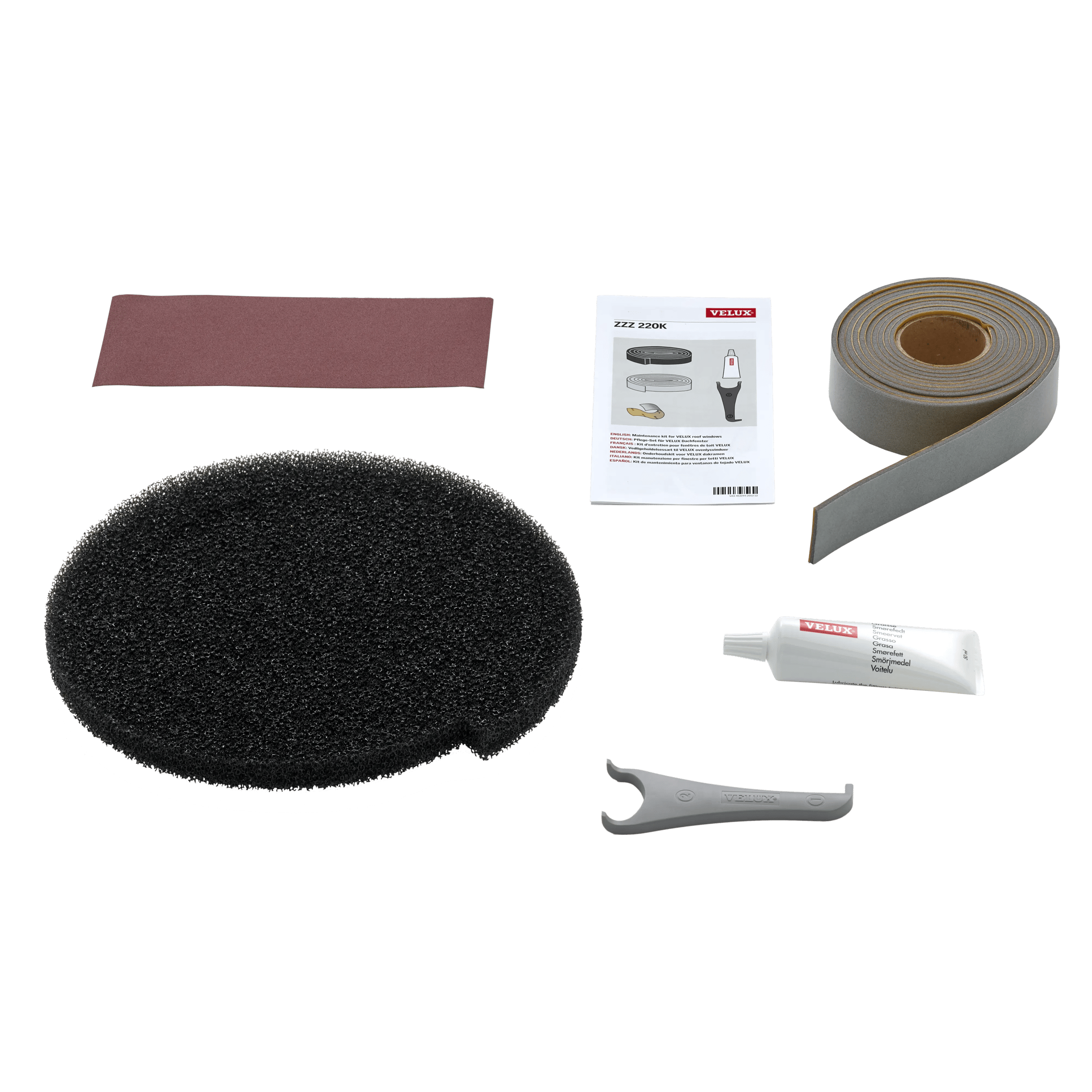 VELUX maintenance kit with foam pad, sandpaper, lubricant, sealing tape, and manual.