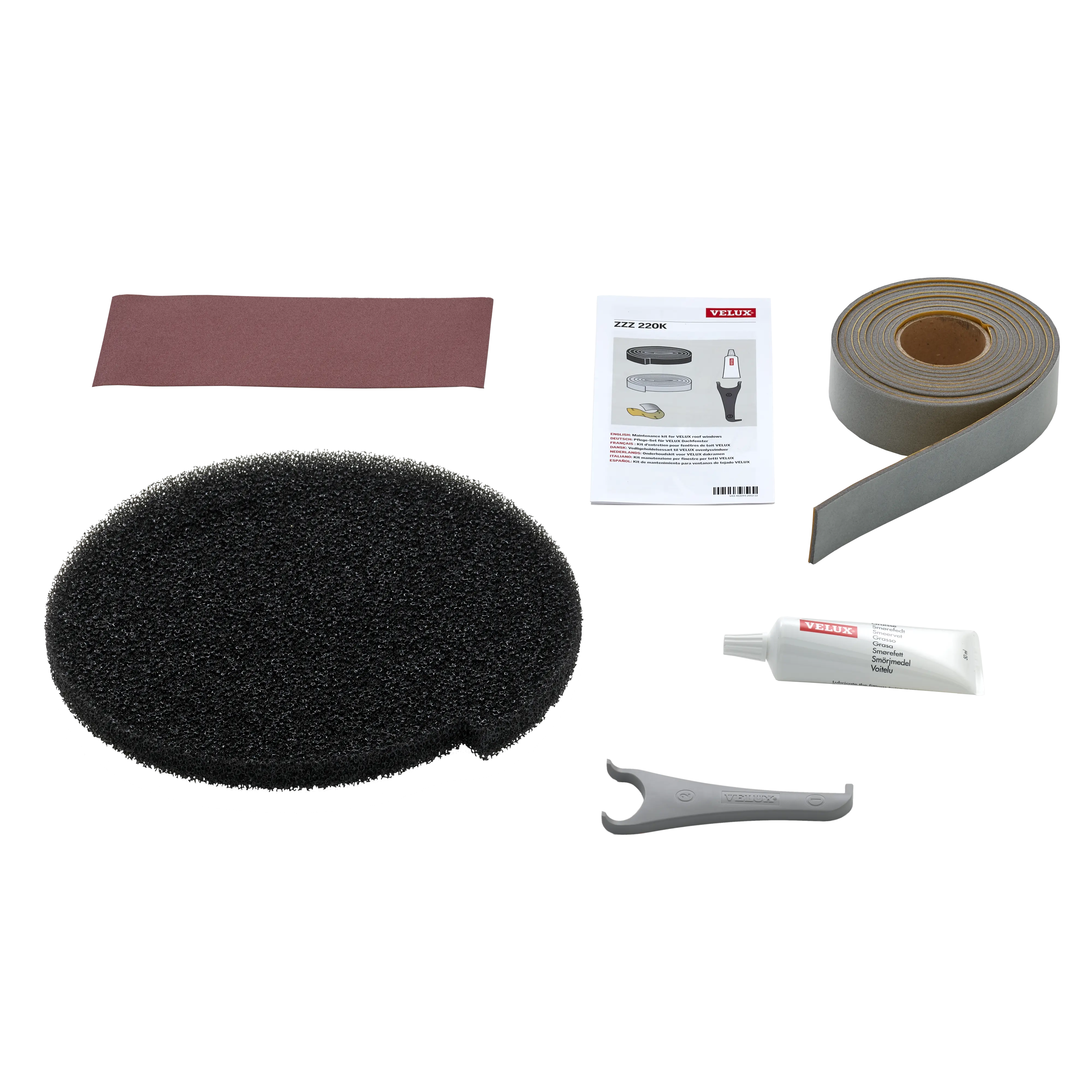 VELUX maintenance kit with foam pad, sandpaper, lubricant, sealing tape, and manual.