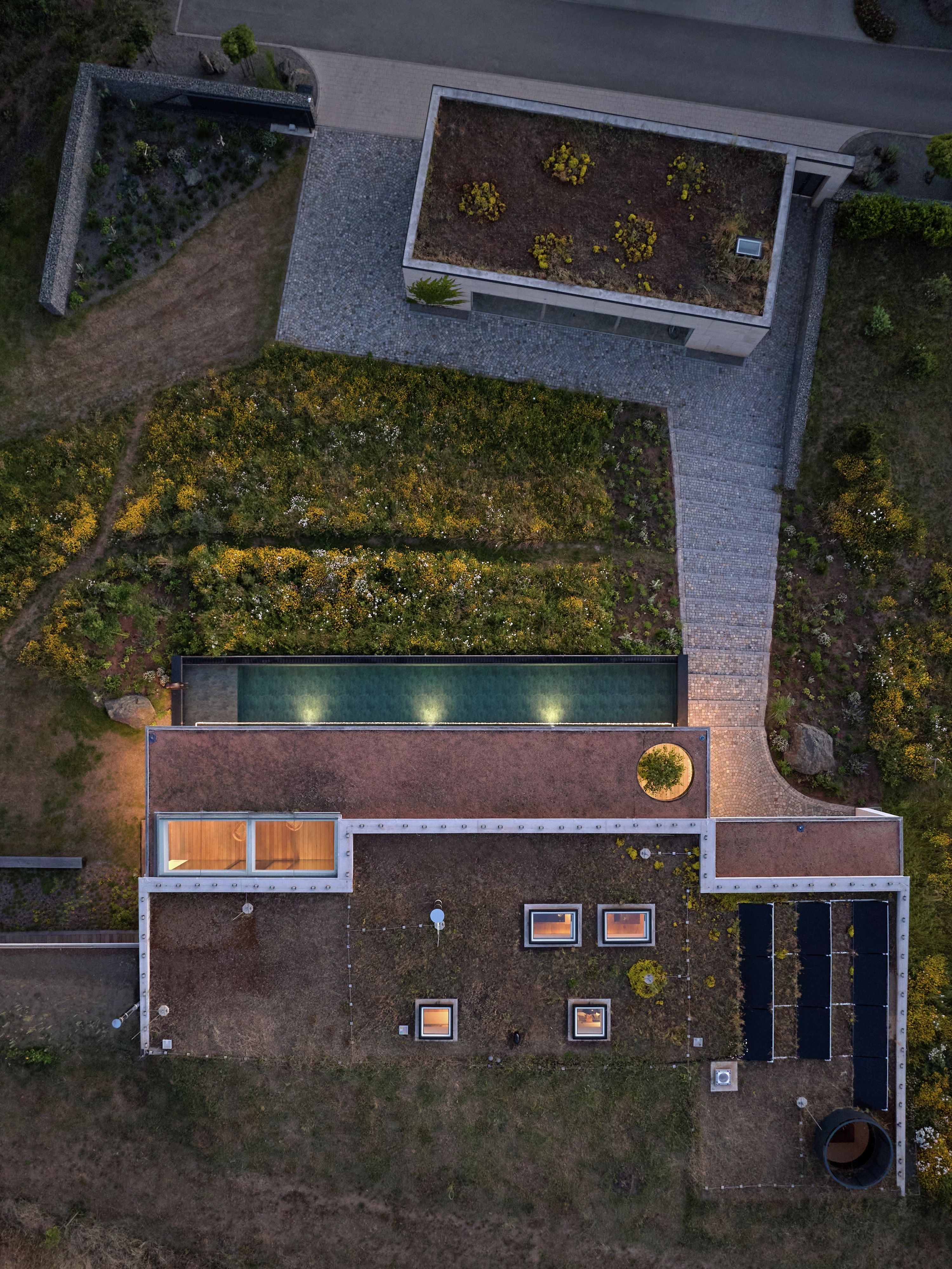 Aerial view of modern flat roof house with VELUX flat roof windows, pool and solar panels.