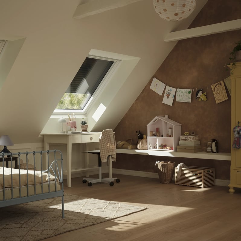 Attic kid's room with sloped ceiling and VELUX roof windows and shutters, playful decor.