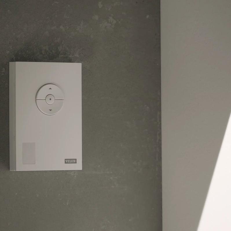 VELUX wall control panel on a textured wall, minimalist design.