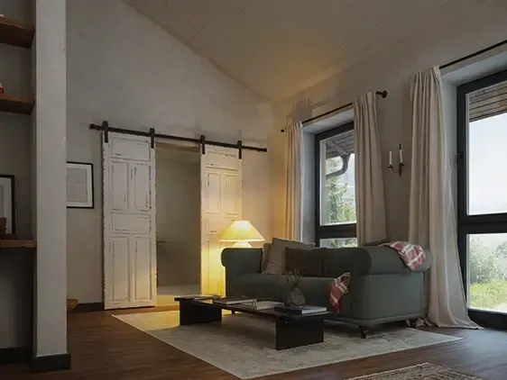Ländliches Wohnzimmer mit grünem Sofa, Scheunentüren und warmem Lampenlicht.