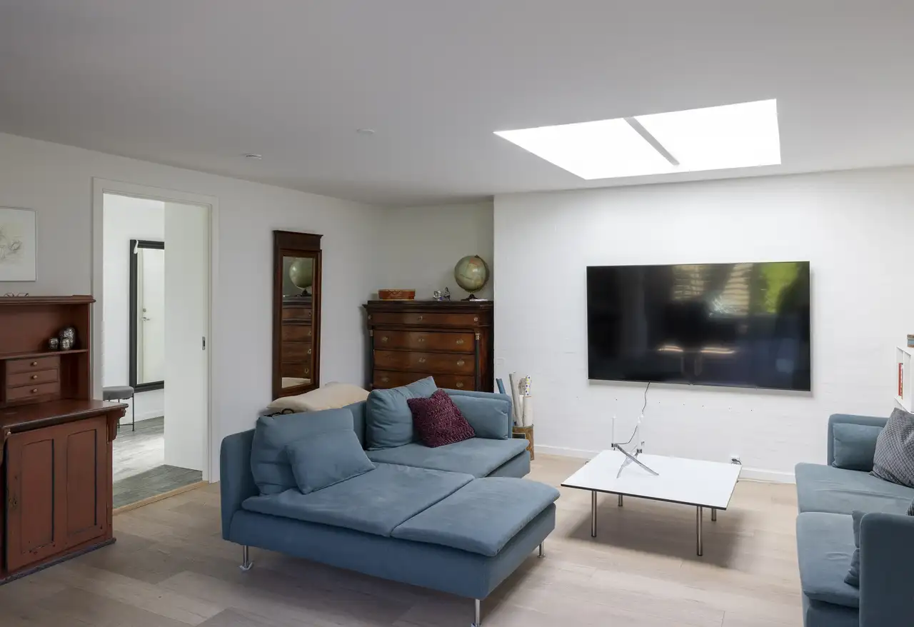 Soggiorno con finestre per tetti piani VELUX, arredamento in stile moderno.
