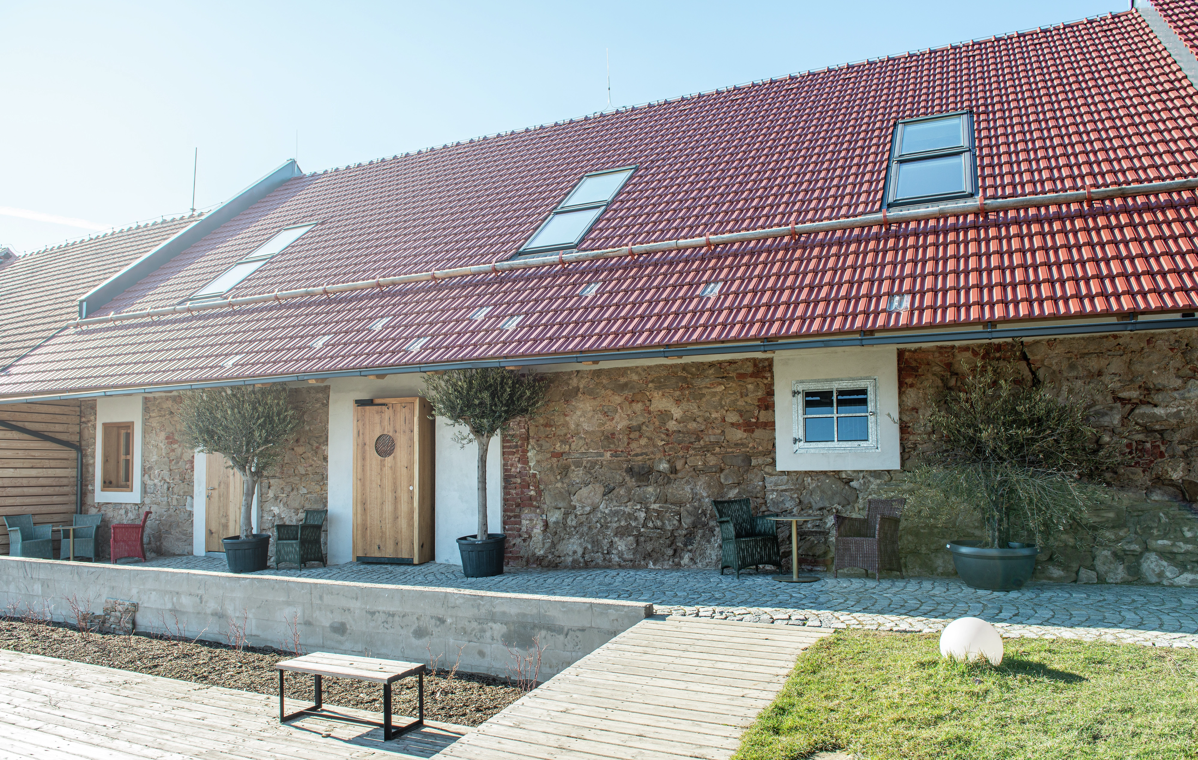 Holiday cottage with red tile roof and VELUX roof windows.
