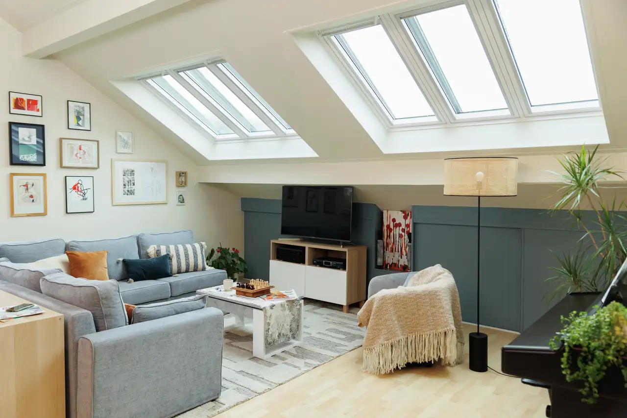 Attic bedroom with sloped ceiling and VELUX roof windows, modern decor
