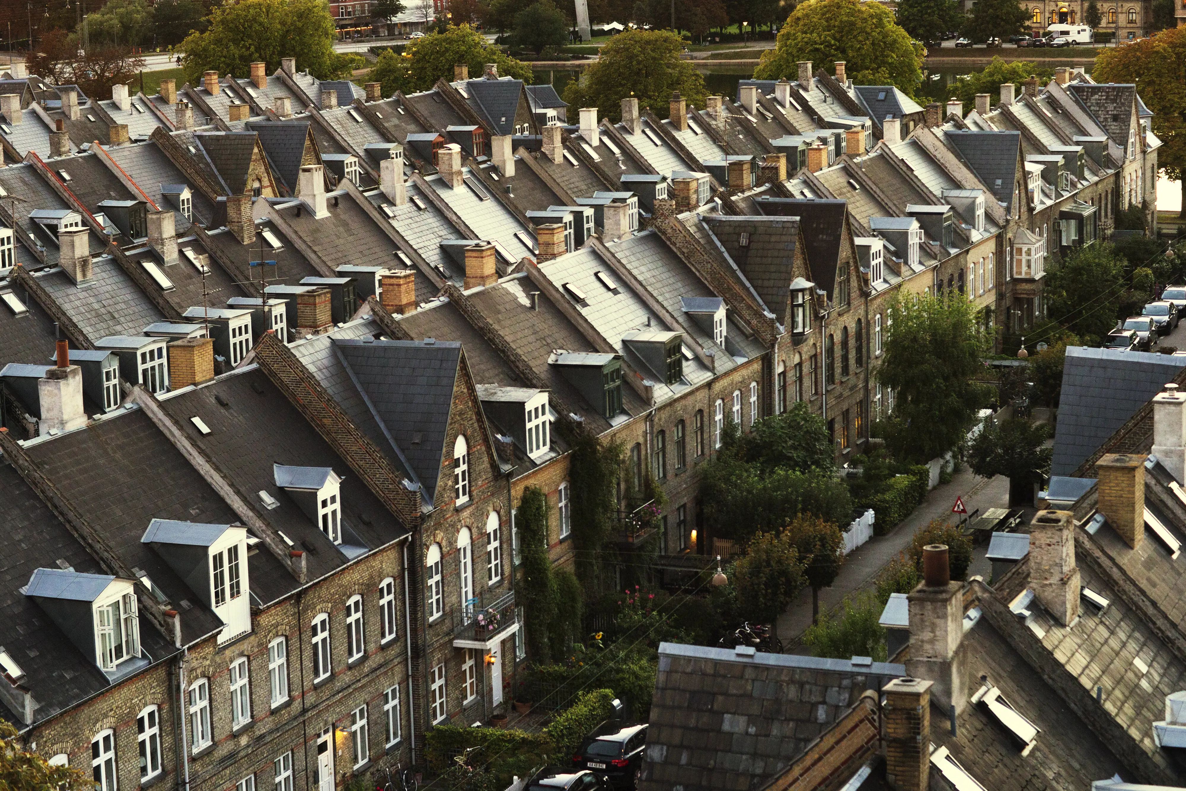 Terraced houses with steep slate roofs and lush greenery.
