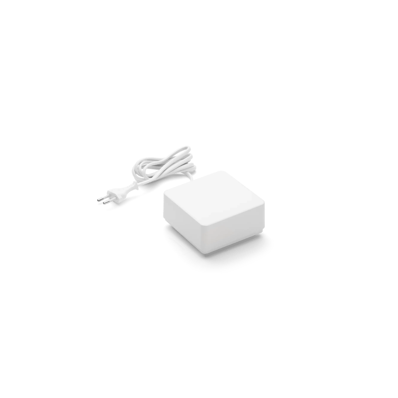White power adapter with cable on black background.