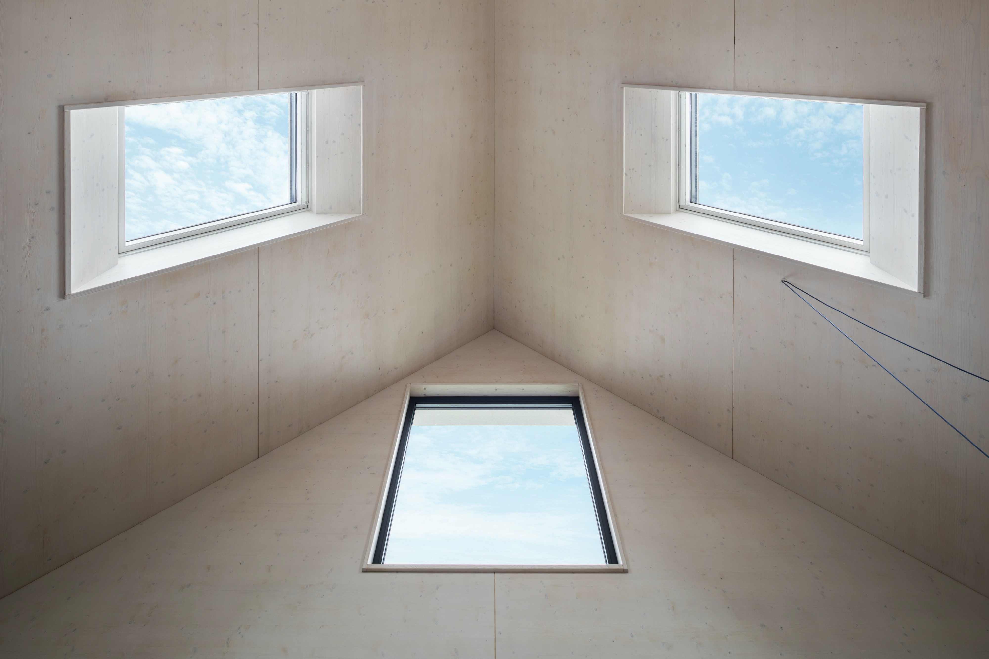 Attic with high-pitched ceiling and VELUX roof windows, bright and airy.