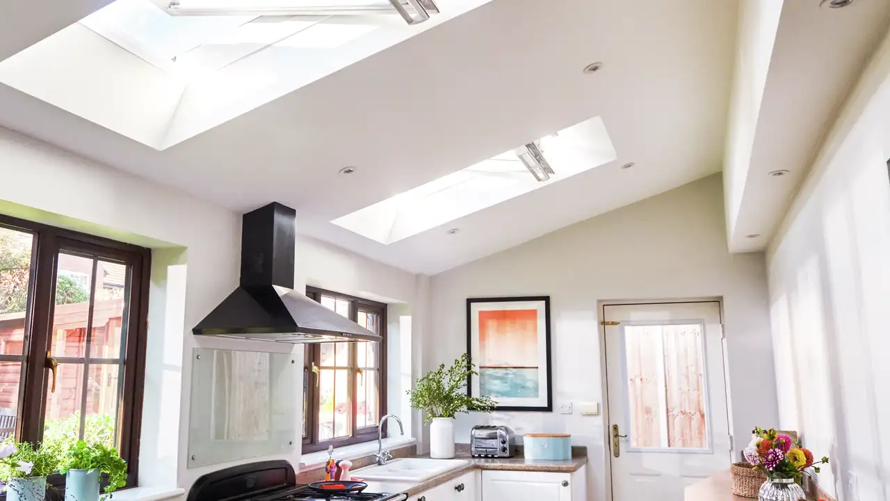Modern kitchen with VELUX roof windows, natural light and garden view 