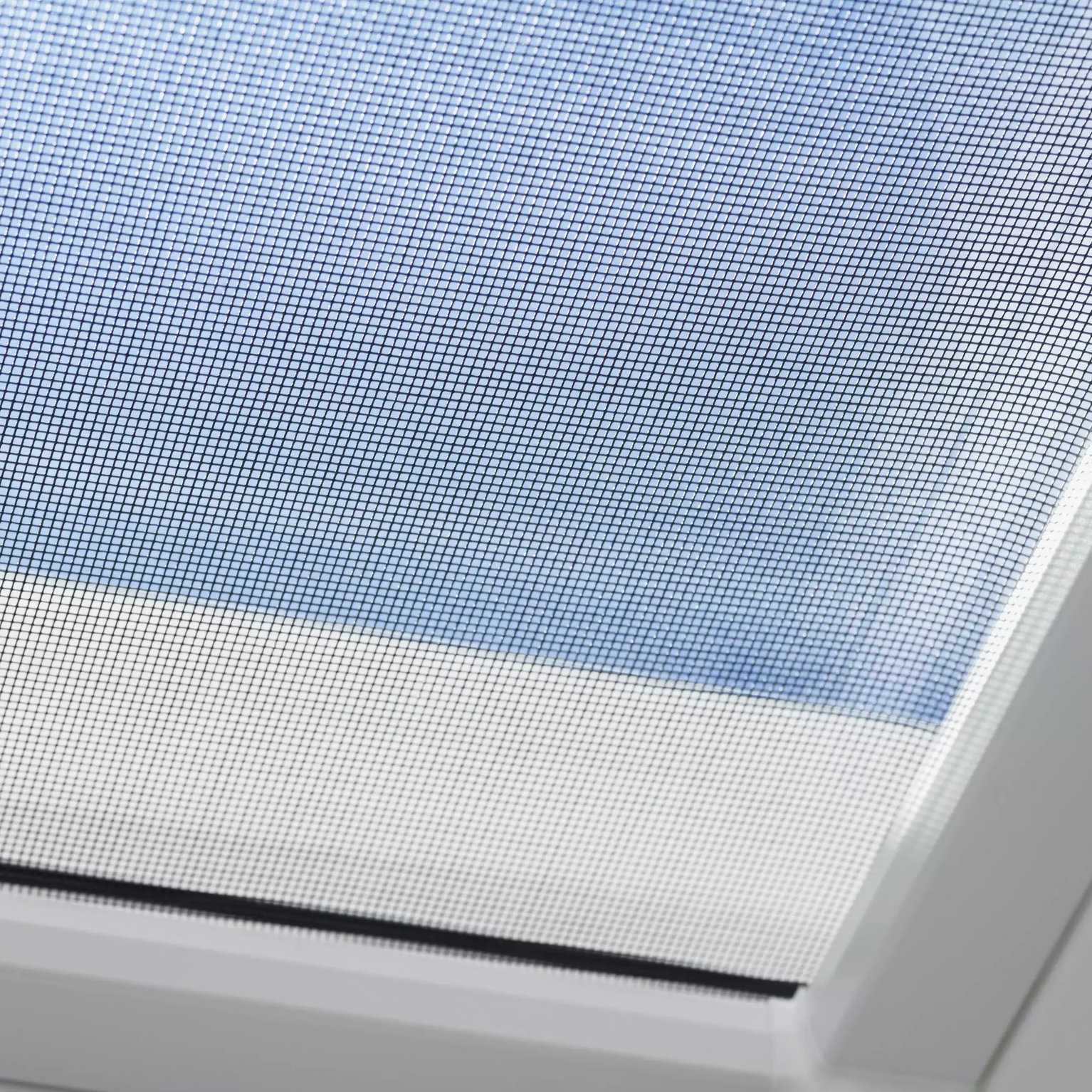 VELUX roof window with mesh screen, natural light filtering through.