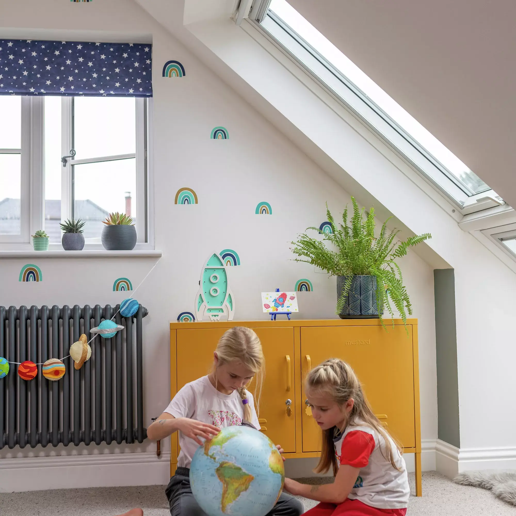 Children playing in room with VELUX roof windows