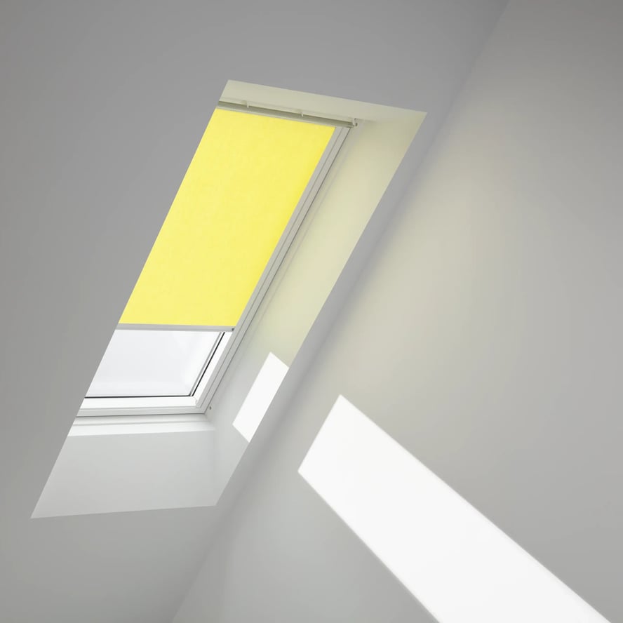 Attic room with VELUX roof window and yellow blind, natural light entering.