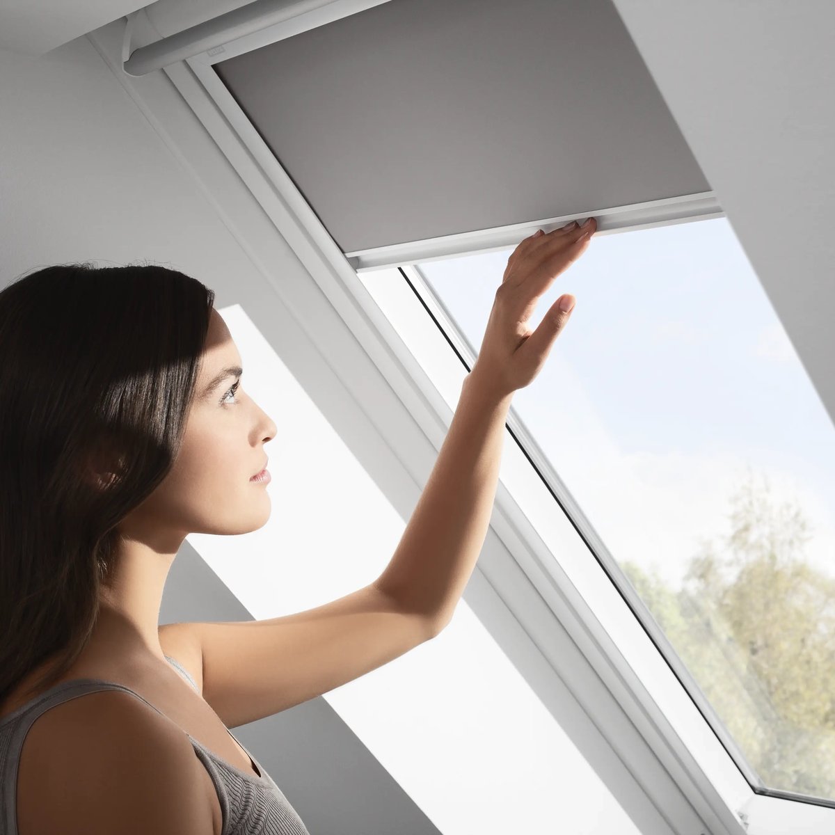 Attic room with VELUX roof window, sloped ceiling, natural light.