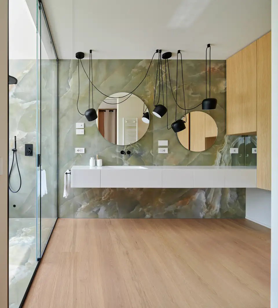 Modern bathroom design featuring quality lighting and mirrors