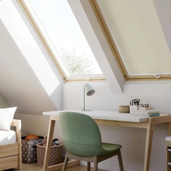 Attic kids room with sloped ceiling and VELUX roof windows.