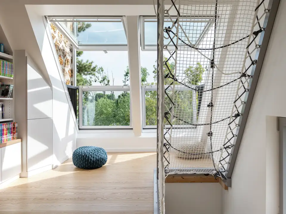 Attic room with VELUX roof windows, sloped ceiling, and reading nook.