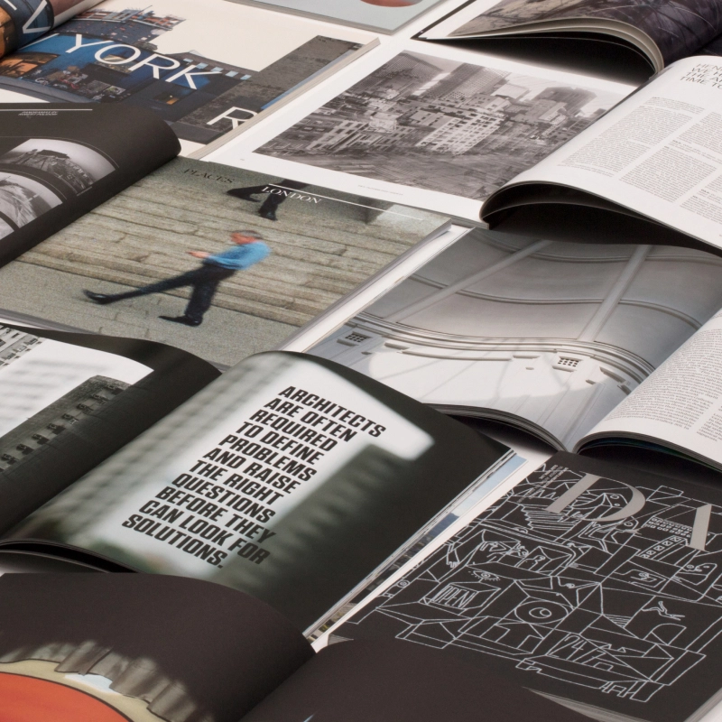 Open magazines displaying articles and images on architecture and art.