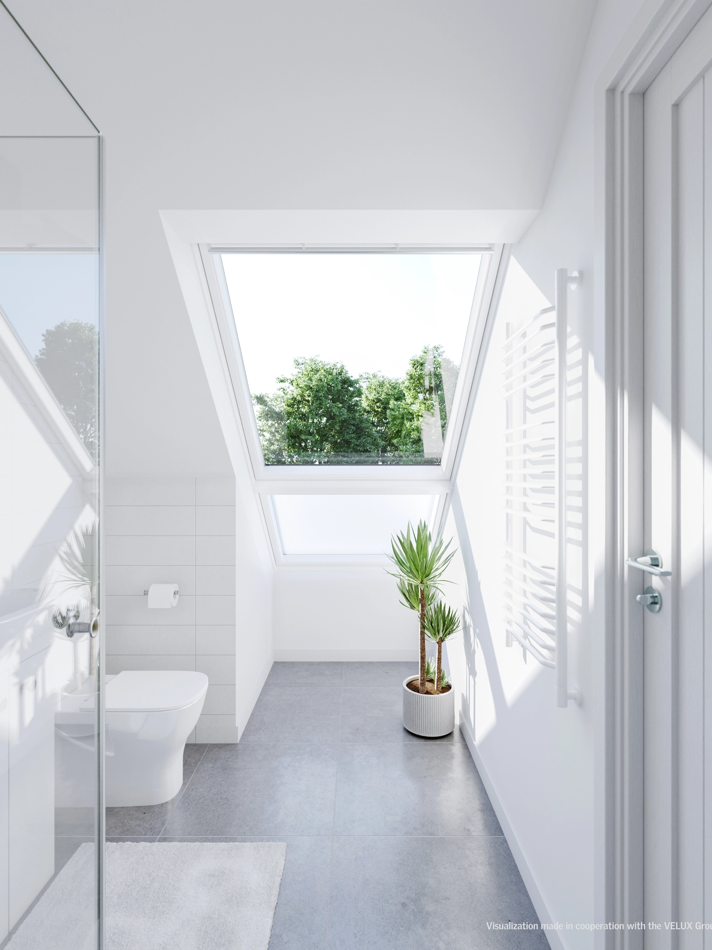 Bright bathroom with a sloped ceiling and a large VELUX roof window, natural light entering.