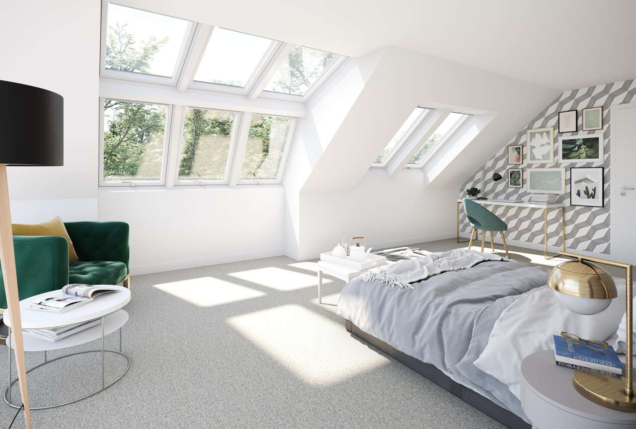 Ruhiges Schlafzimmer im Dachboden mit VELUX Dachflächenfenstern und minimalistischer Dekoration.