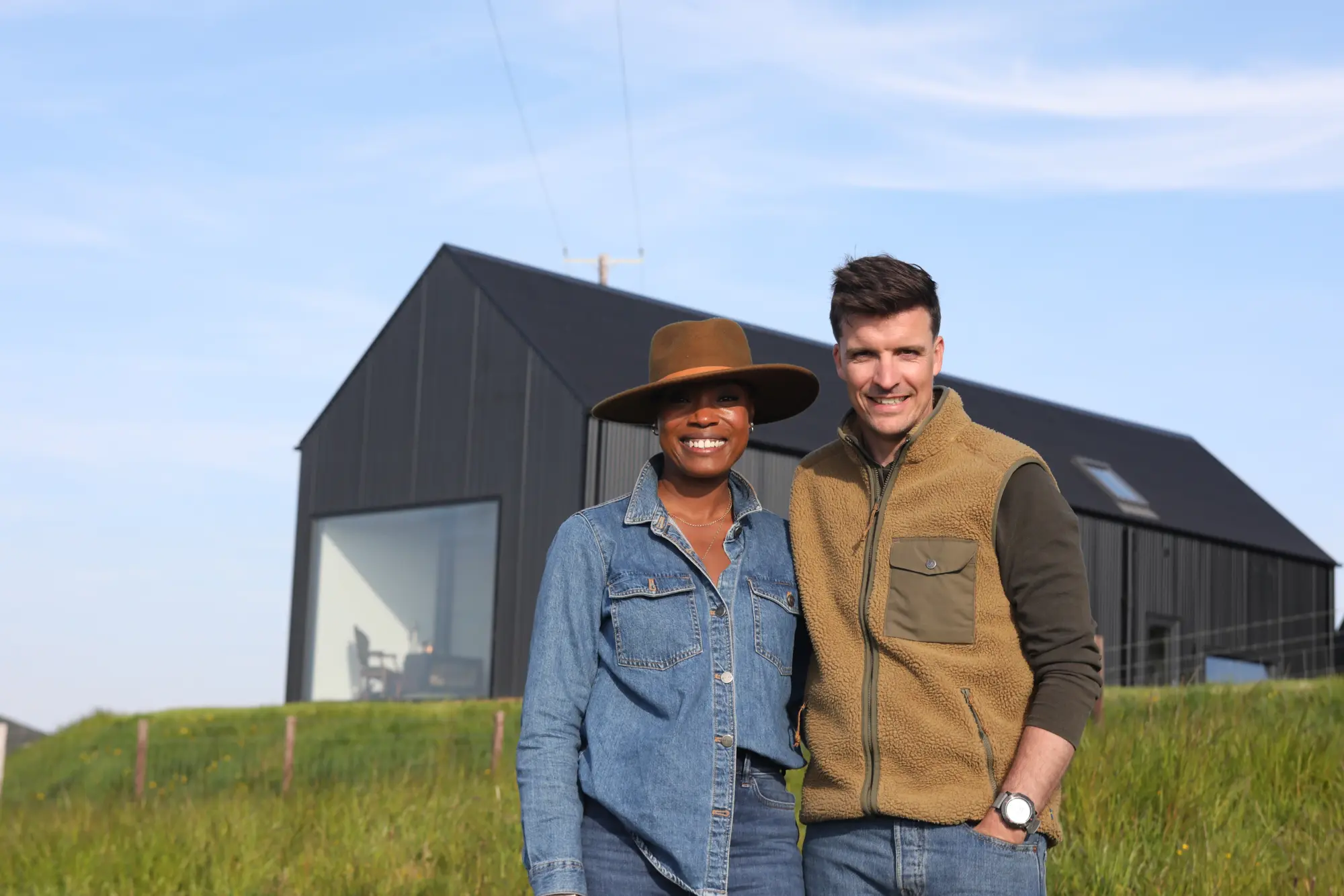 Man and woman standing in front of their home