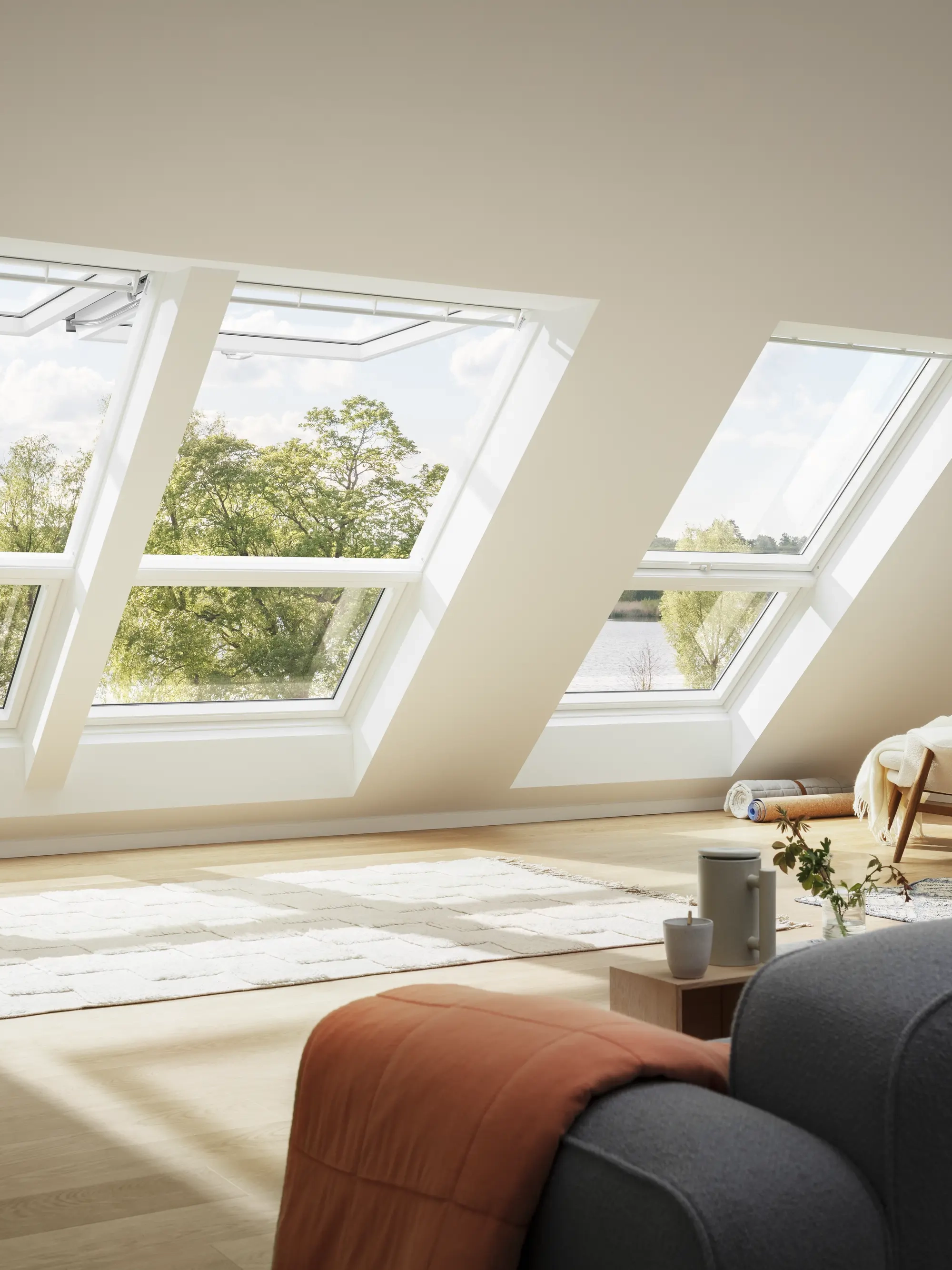 Attic room with large VELUX roof windows, natural light and cozy furnishings.