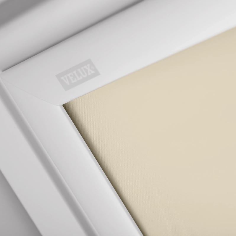 Close-up of VELUX roof window with white frame and beige blind.