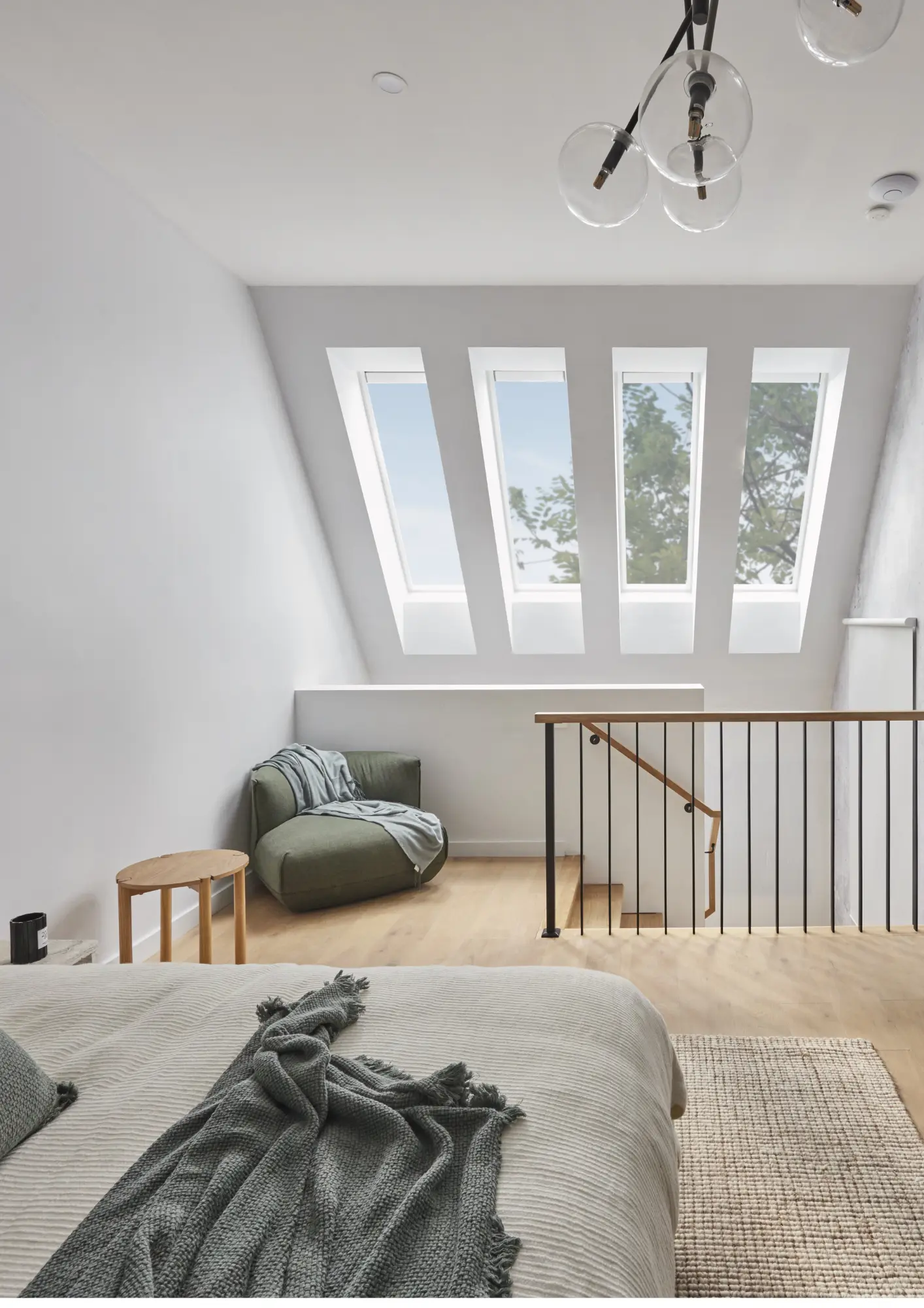 Attic bedroom with VELUX roof windows and cozy furnishings.