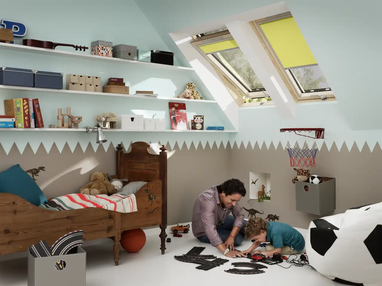 Chambre d’enfant sous combles avec un mur bas peint dans une teinte plus foncée que le plafond clair.