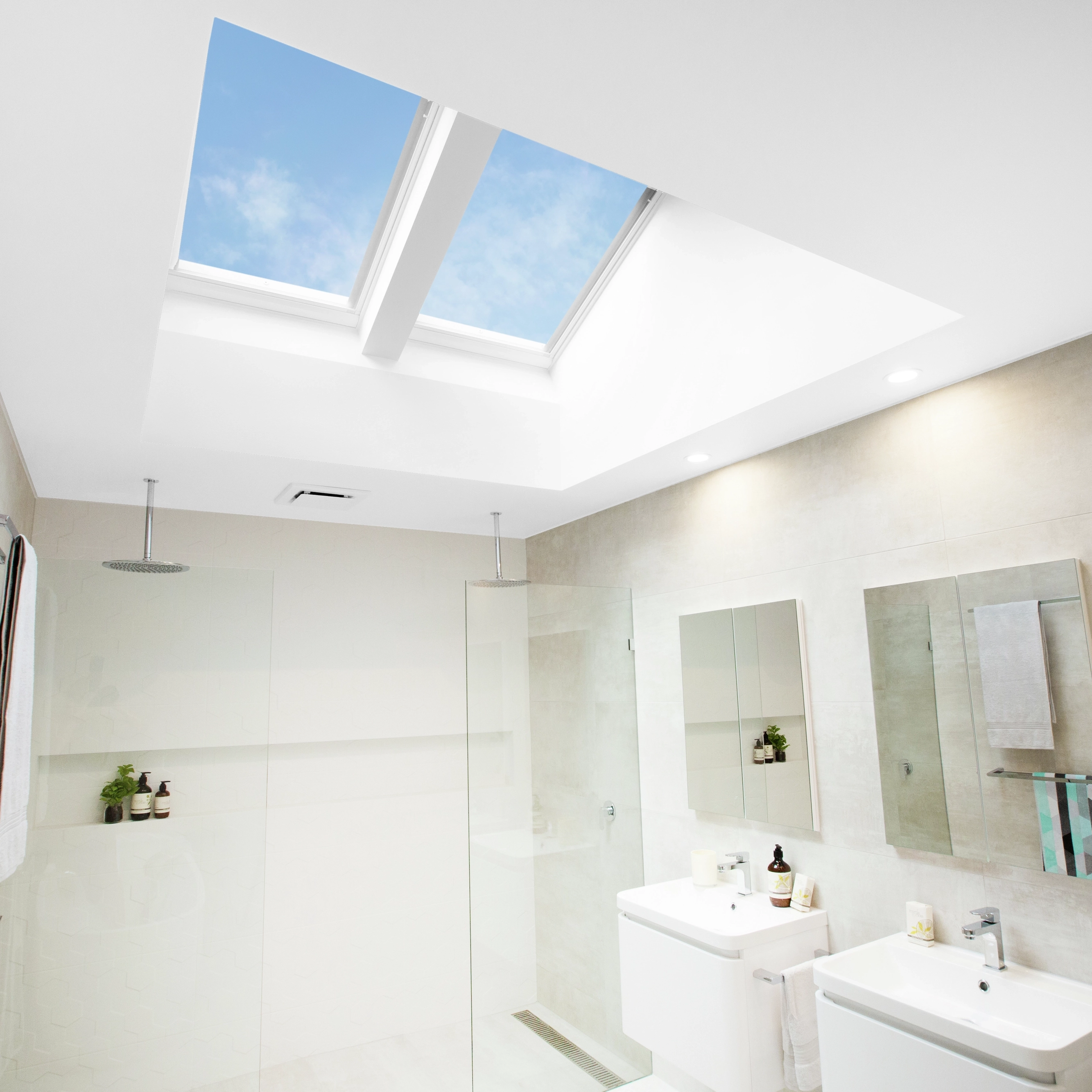 Bathroom with flat ceiling and VELUX roof windows, bright and modern design.