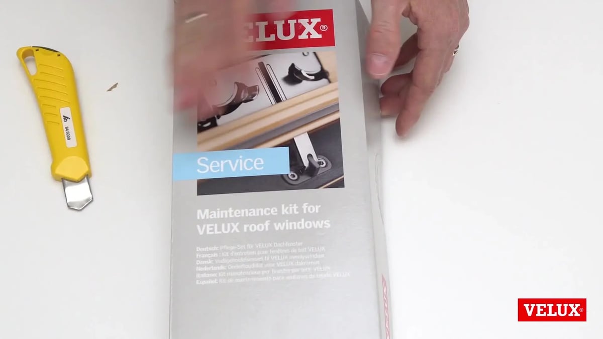 Installation process of a VELUX roof window with visible branding.