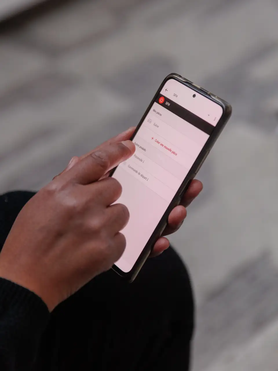 Un homme contrôle les fenêtres de toit et les stores depuis son smartphone