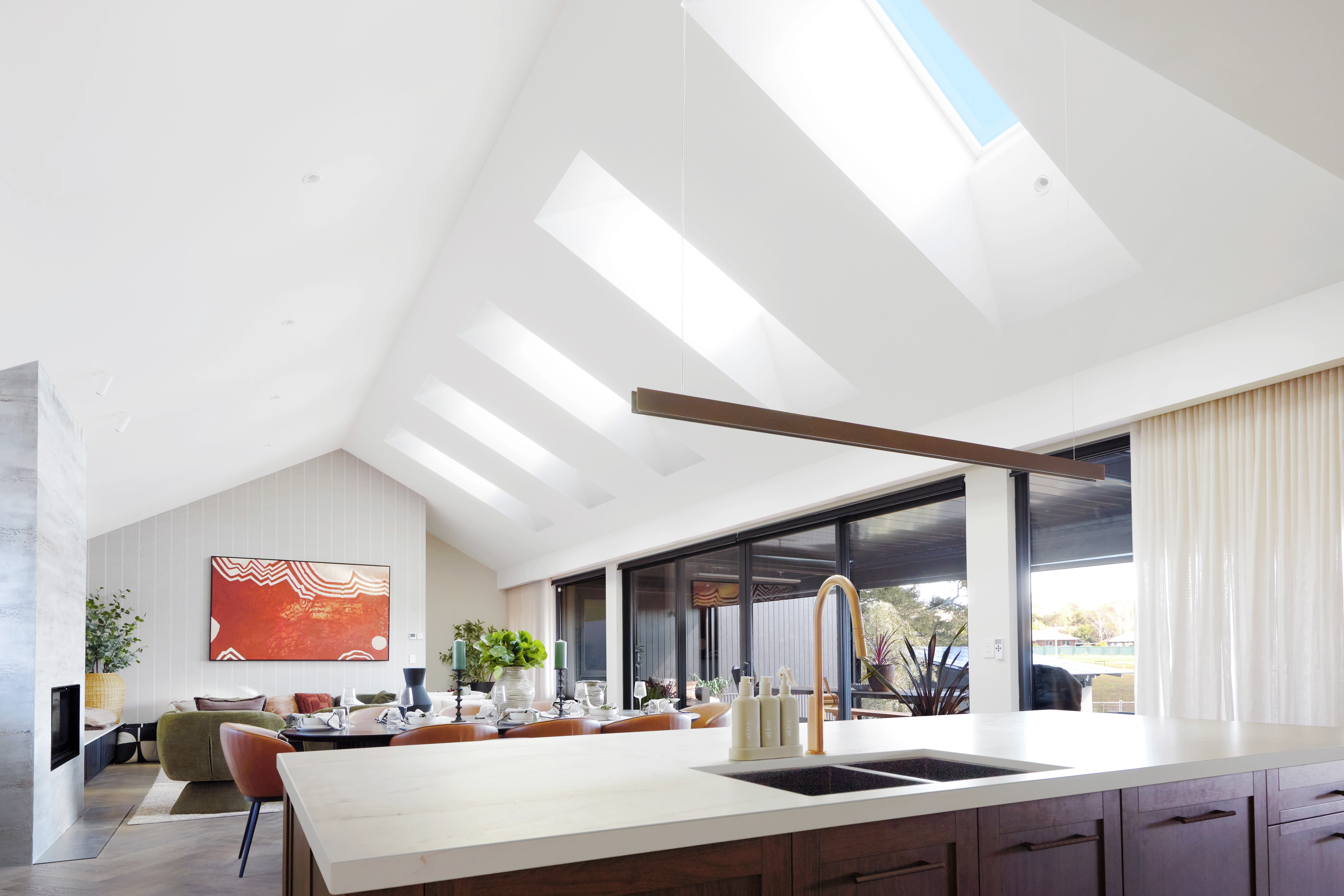 Living area with sloped ceiling and VELUX roof windows.