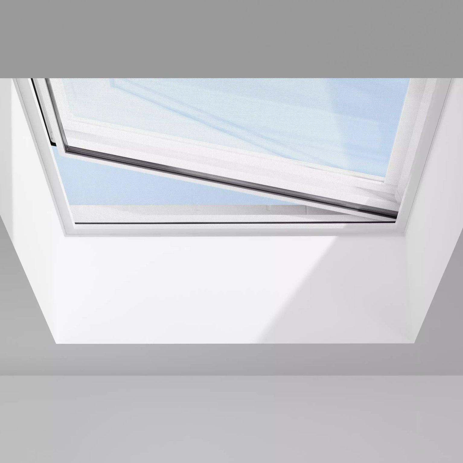 Open VELUX roof window with natural light entering.