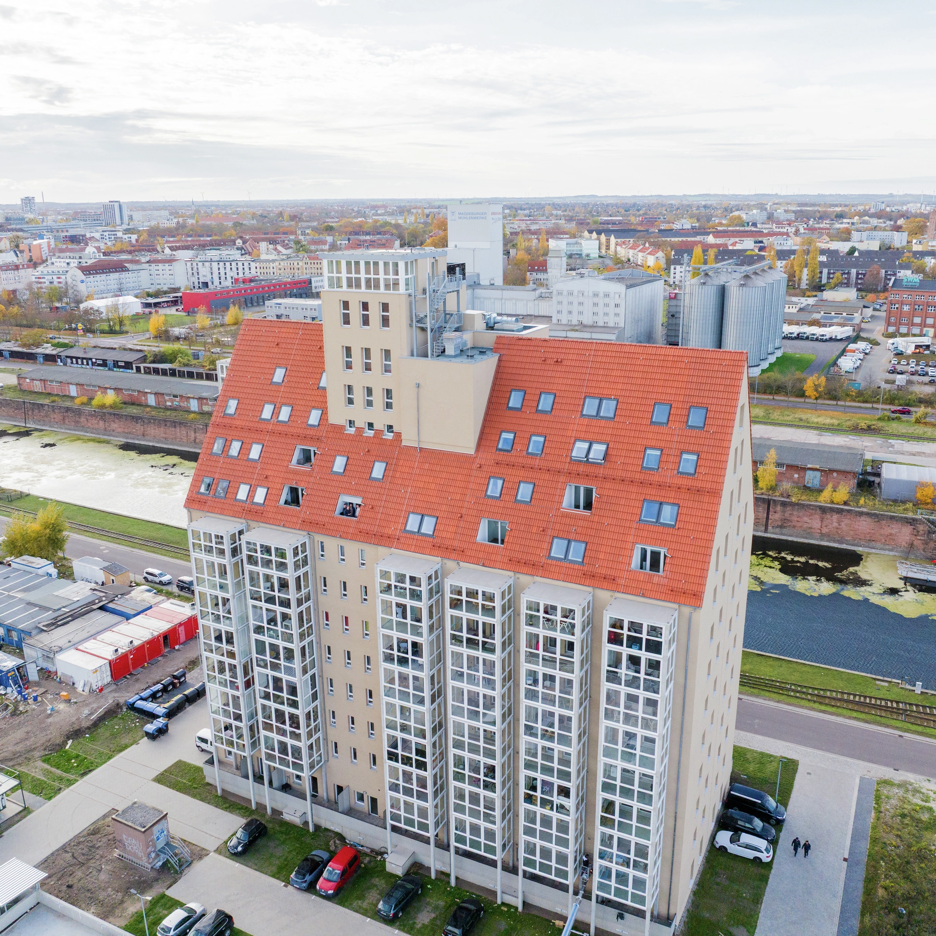 Apartment building with red tile roof and VELUX roof windows.
