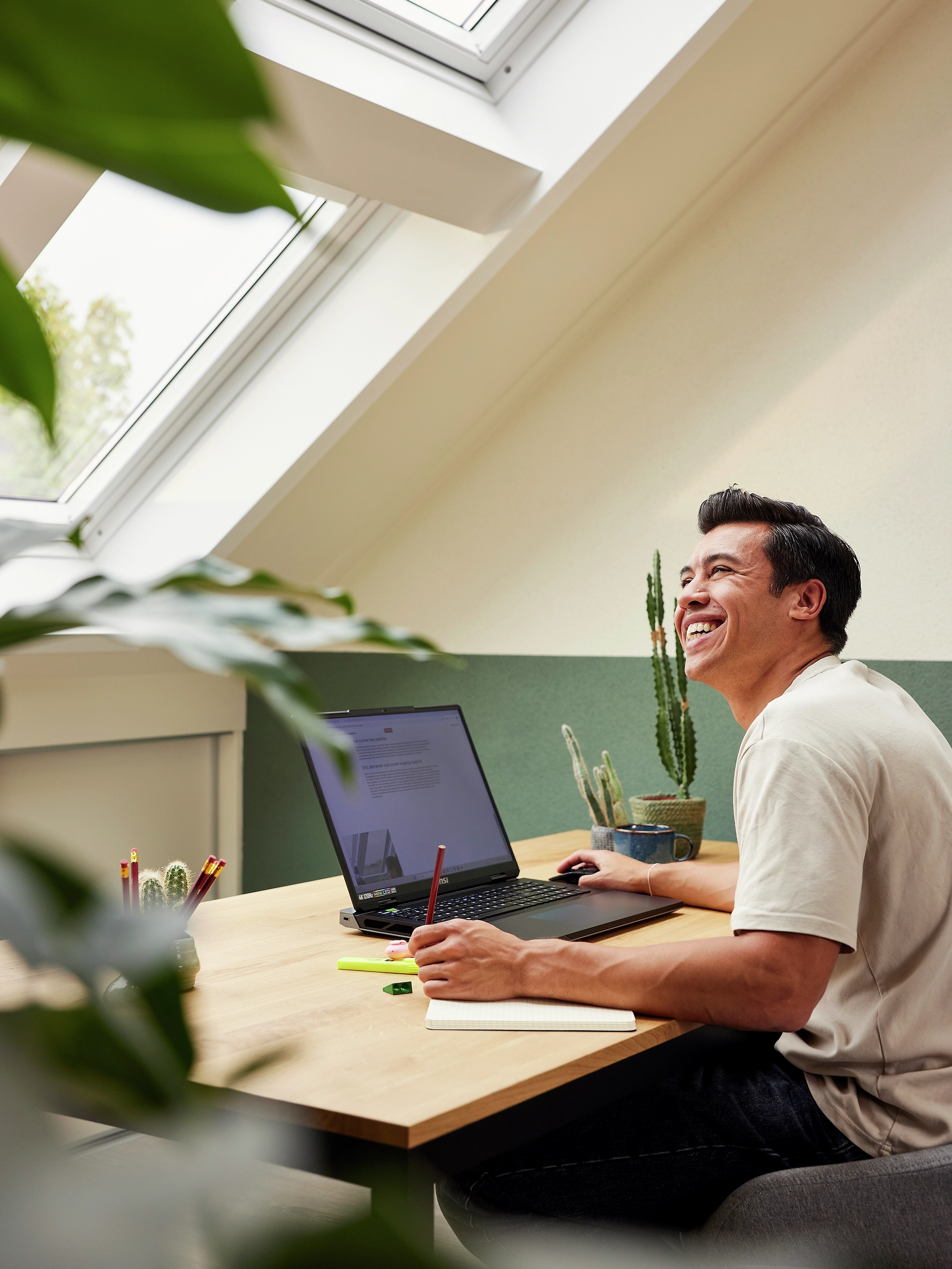 Dylan aan zijn bureau onder de Quattro VELUX dakramen.