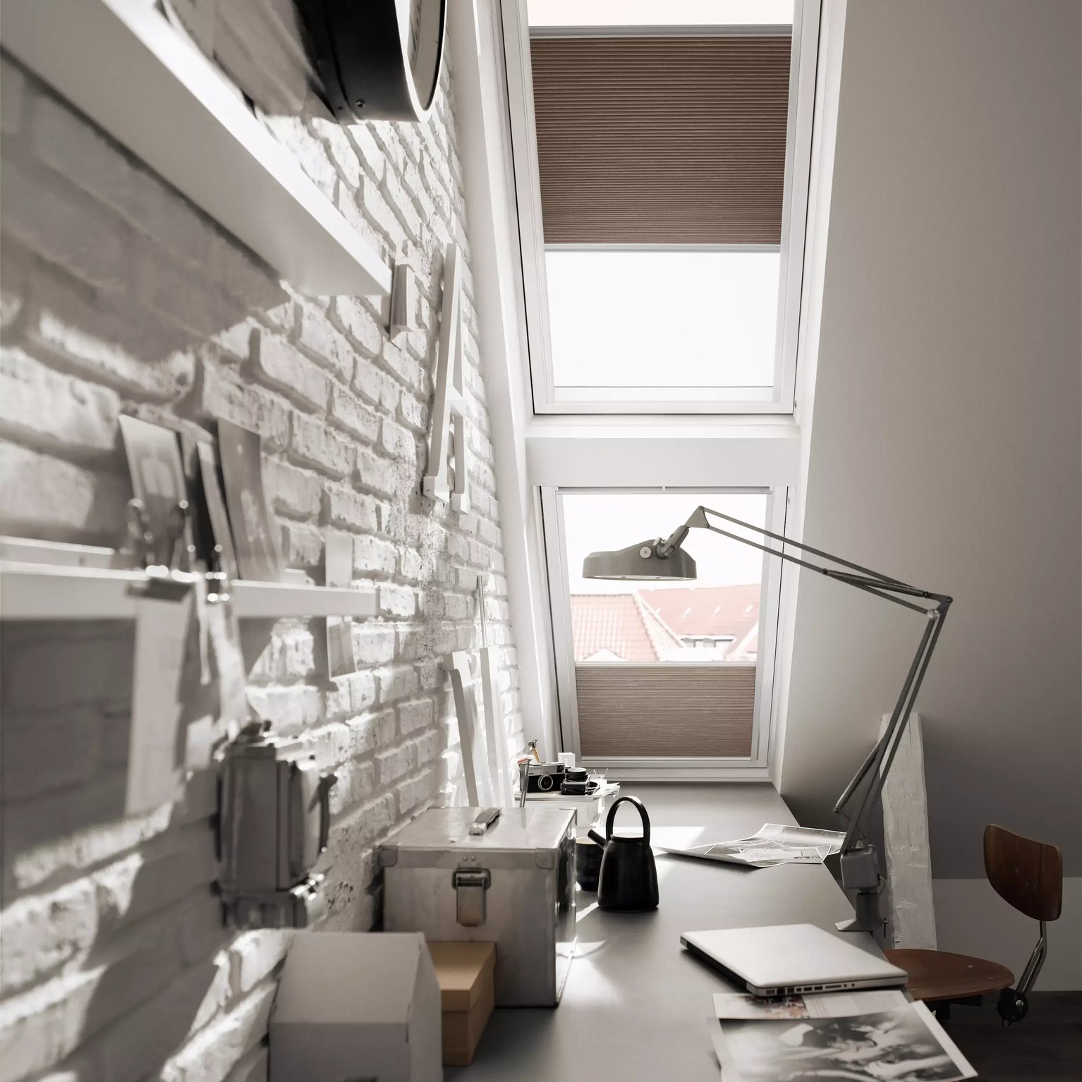 Attic workspace with sloped ceiling and VELUX roof window, modern design.
