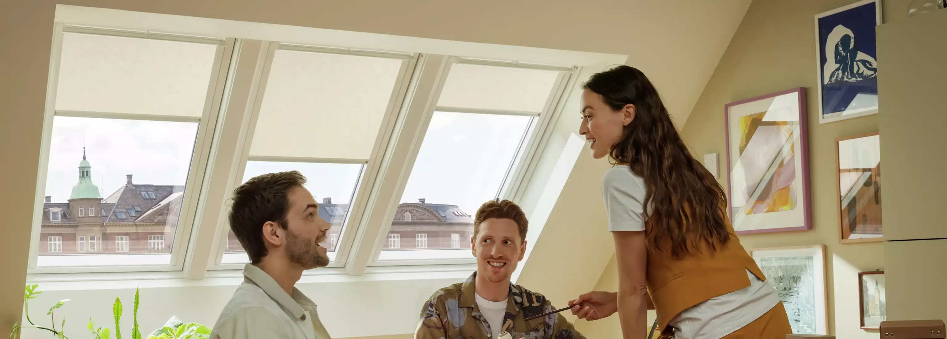 Attic office with VELUX roof windows, people in a meeting.